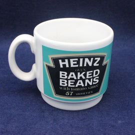 White mug with Heinz Baked Beans label on a blue background