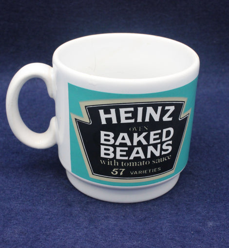 White mug with Heinz Baked Beans label on a blue background
