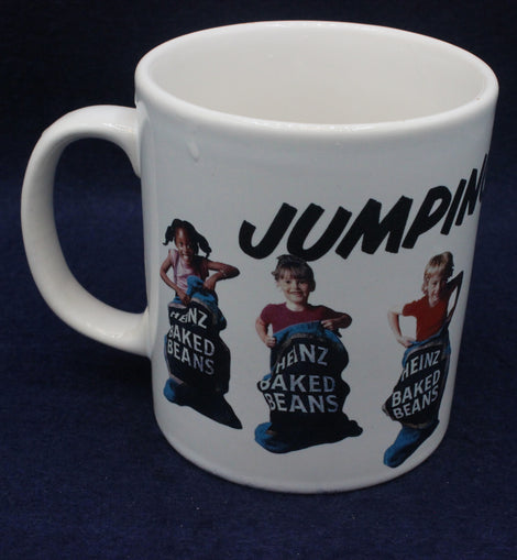 White mug with Heinz baked beans graphic and 'Jumpin' text on a dark background