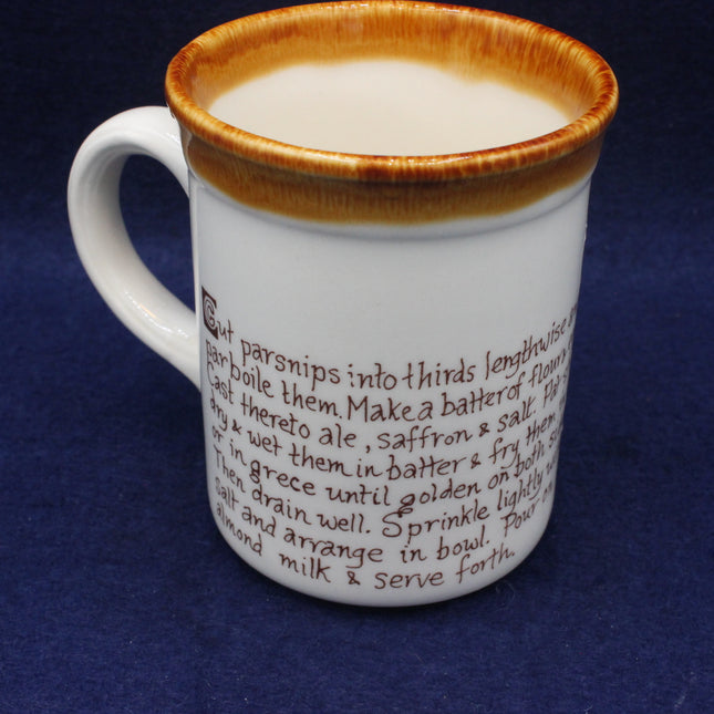 White mug with brown rim and printed text on a blue background