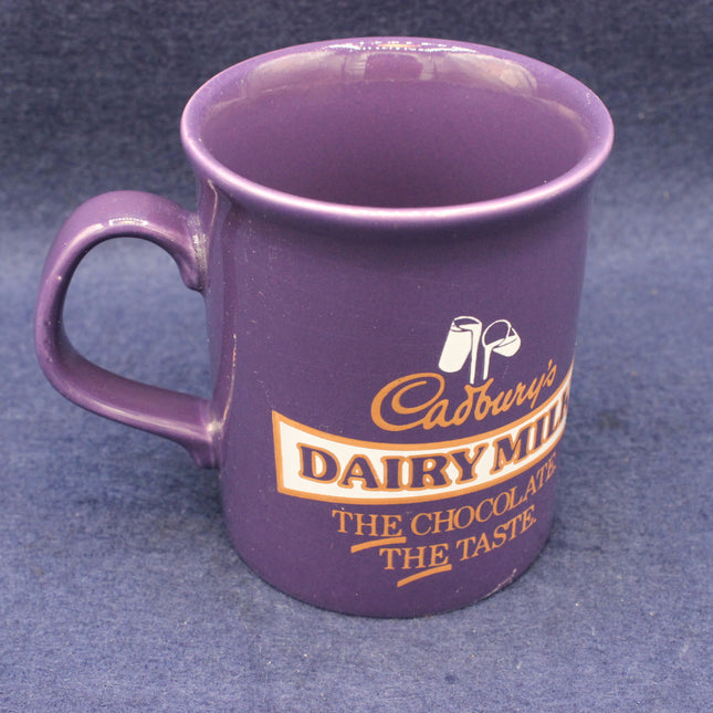 Purple mug with Cadbury Dairy Milk branding on a blue background