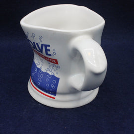 White mug with blue and red graphics on a dark blue background
