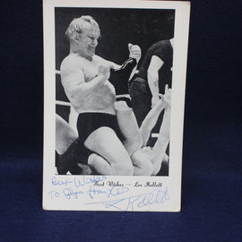 Vintage wrestling photograph owith autograph on a dark background Les Kellet 