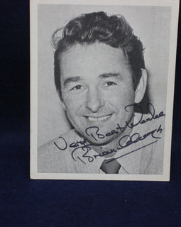 Black and white photo of a Brian Clough with autograph on a dark background