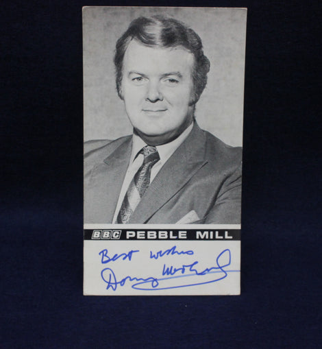 Vintage card with a black and white photo of a man in a suit and tie, signed 'Best wishes' by 'Donny Macleod', on a dark background.