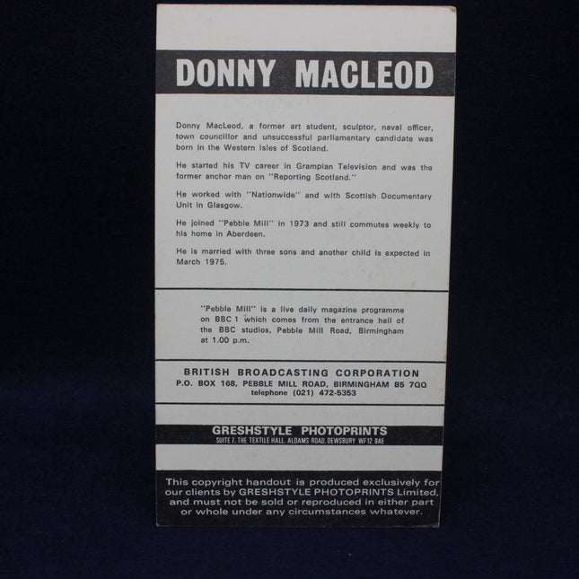 Back of a card with text about Donny Macleod and British Broadcasting Corporation, on a black background.