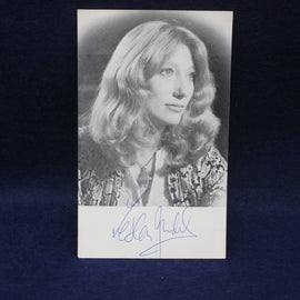 Black and white photo of Leslie Judd with a signature below on a dark background