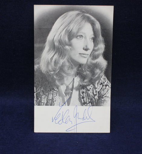 Black and white photo of Leslie Judd with a signature below on a dark background