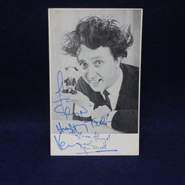 Autographed photo of comedian ken Dodd  with a dark background