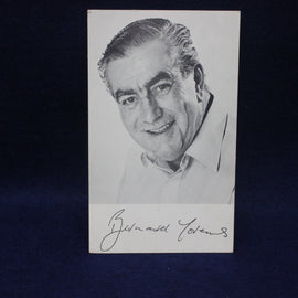 Black and white portrait photo of Bernard Youens with signature on a dark background