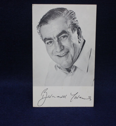 Black and white portrait photo of Bernard Youens with signature on a dark background