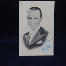 Vintage portrait of a man in formal attire with a signature on a dark background