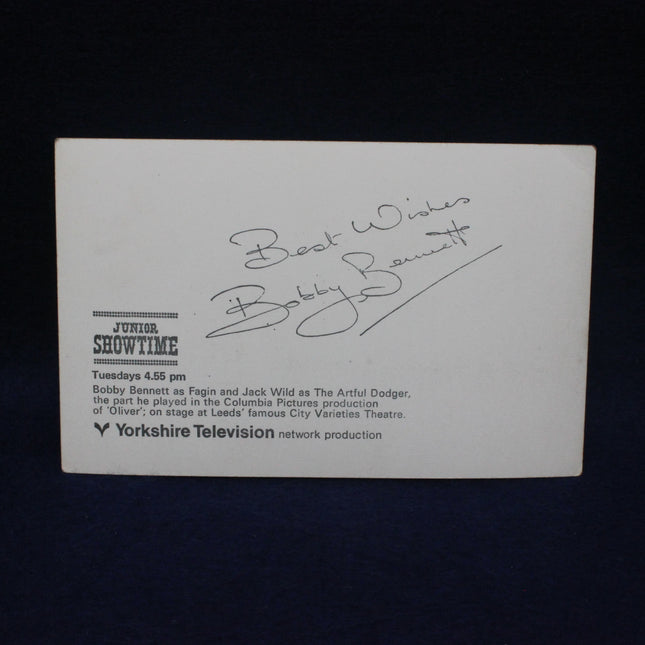 Vintage card with text and signature on a dark background