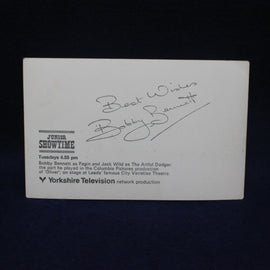 Vintage card with text and signature on a dark background