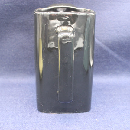 black JPS jug on a textured blue background