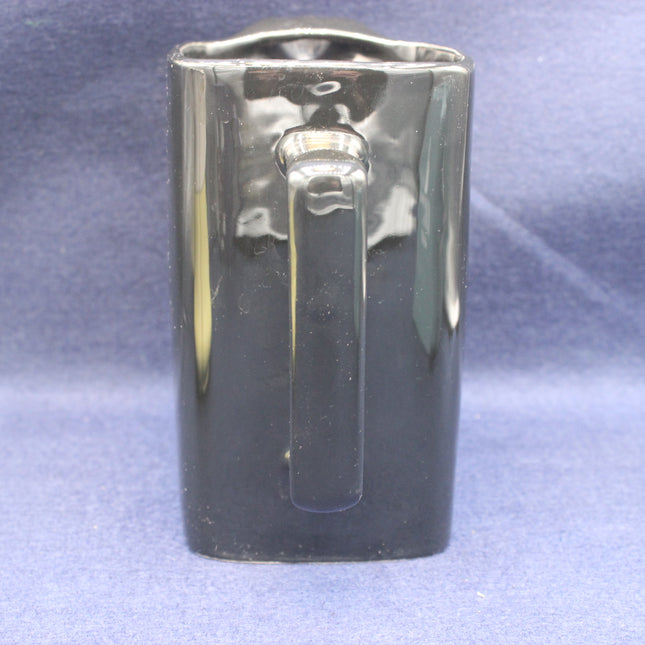 black JPS jug on a textured blue background