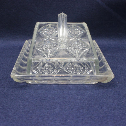 Clear glass dish with star patterns on a dark blue background