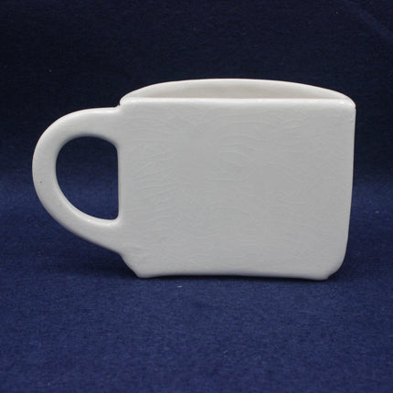 White ceramic mug on a dark blue background