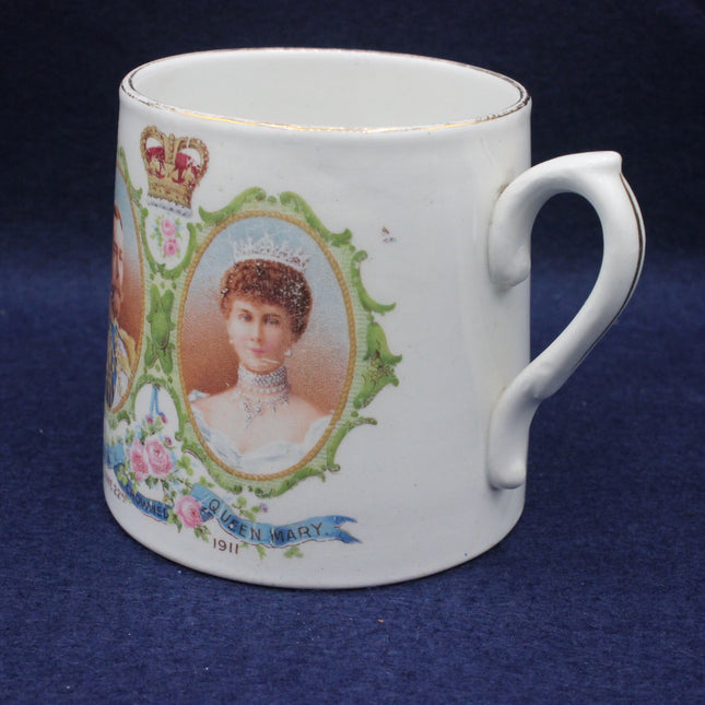 White mug with decorative royal portrait and floral design on a dark blue background