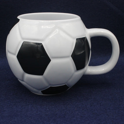 Soccer ball-shaped mug on a dark blue background