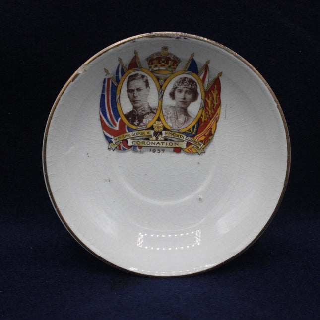 Decorative plate with royal portraits and British flags on a dark background