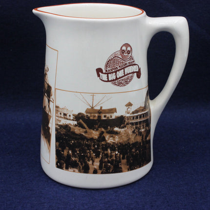 White ceramic mug with vintage-style image and logo on a dark blue background