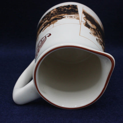 White mug with brown and red patterns on a dark blue background