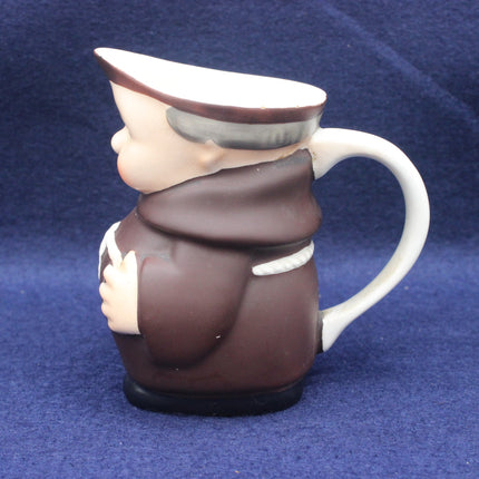 Ceramic mug shaped like a person in uniform on a blue background