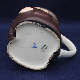 Ceramic mug with a brown rim on a blue background