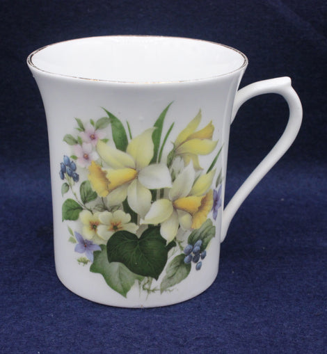 White mug with floral design on a dark blue background