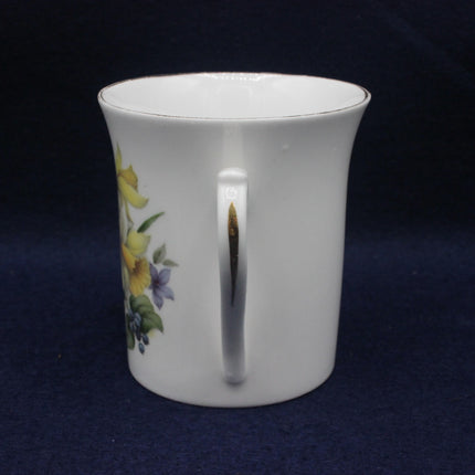 White ceramic mug with floral design on a dark blue background