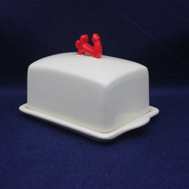 White Anchor butter dish with red handles on a dark blue background