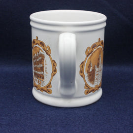 White mug with gold decorative patterns on a blue background