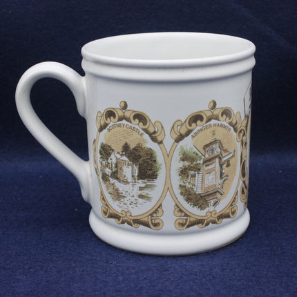 White mug with decorative brown designs on a blue background