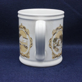 White mug with gold decorative elements on a blue background