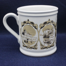 White mug with decorative brown designs on a blue background