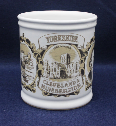 White mug with black and gold Yorkshire-themed design on a blue background
