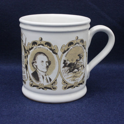 White mug with historical design featuring a portrait and landscape on a blue background