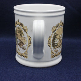 White mug with gold and brown designs on a blue background