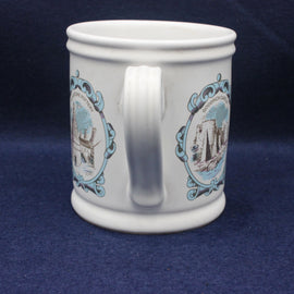 White mug with decorative blue and brown patterns on a dark blue background