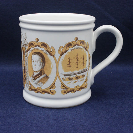 White mug with gold and brown decorative elements on a blue background
