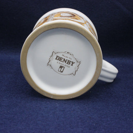 Back view of a ceramic mug with 'Denby England' branding on a dark blue background