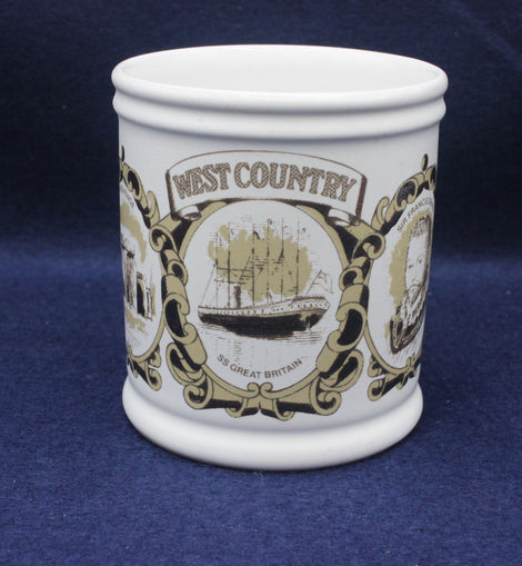 White mug with decorative black and gold design on a blue background