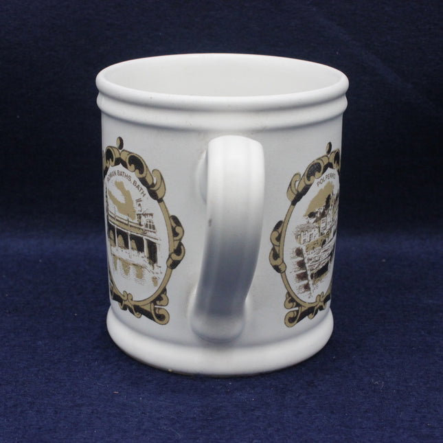 White mug with gold decorative patterns on a dark blue background
