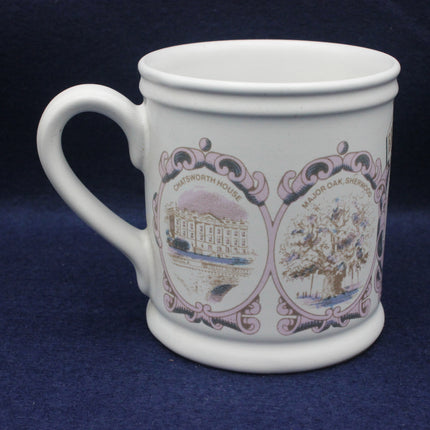 White mug with decorative designs on a blue background