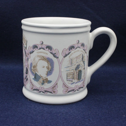 White mug with decorative design featuring a portrait and building on a blue background