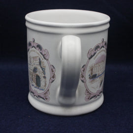 White mug with decorative patterns on a dark blue background