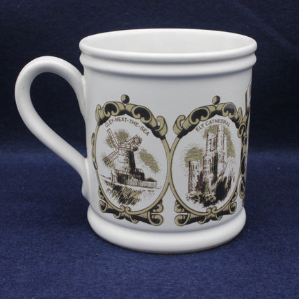 White mug with decorative brown designs on a blue background