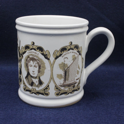 White mug with black and brown decorative design on a blue background