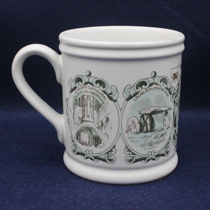 White mug with green decorative designs on a blue background